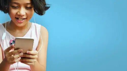 An excited girl uses a phone